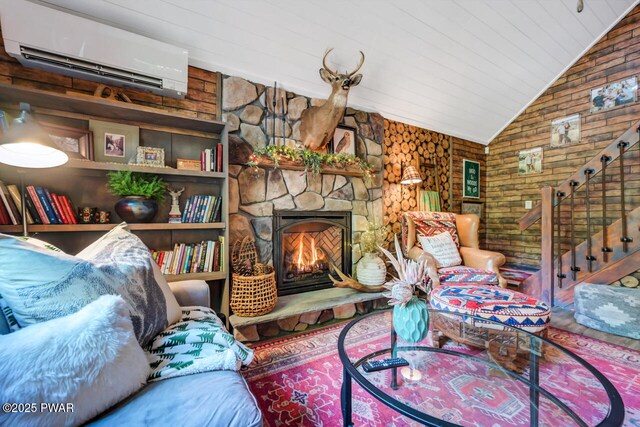 803 Deerfield Rd, Lake Ariel, PA 18436 - living room featuring a wall mounted AC, vaulted ceiling, a fireplace, stairway, and wood walls