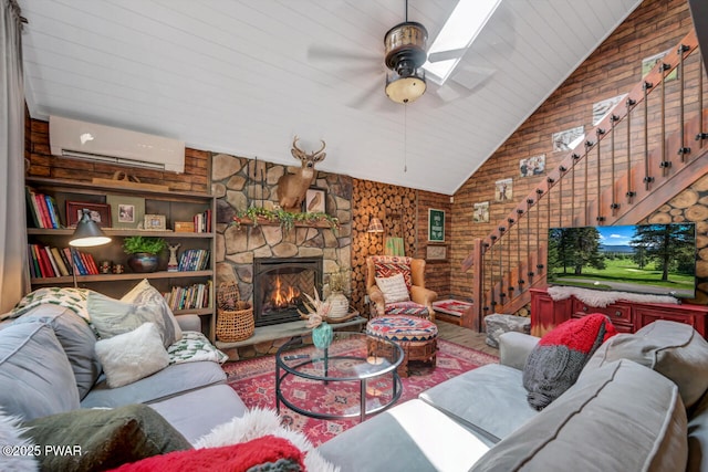 803 Deerfield Rd, Lake Ariel, PA 18436 - living room with an AC wall unit, vaulted ceiling, stairs, a fireplace, and a skylight