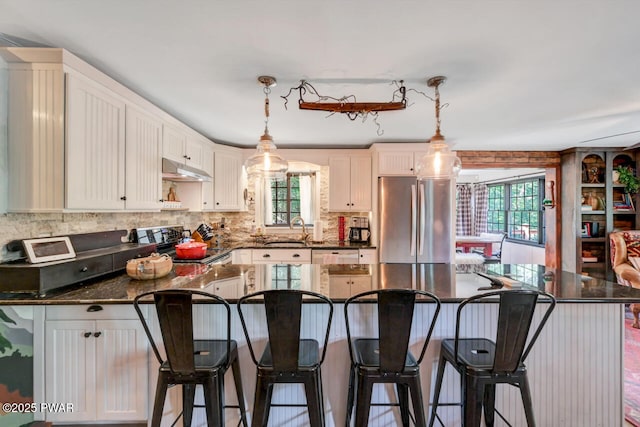 803 Deerfield Rd, Lake Ariel, PA 18436 - kitchen featuring stainless steel appliances, backsplash, a breakfast bar, and decorative light fixtures