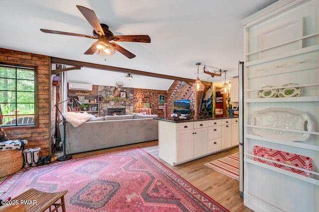 803 Deerfield Rd, Lake Ariel, PA 18436 - kitchen featuring white cabinetry, ceiling fan, dark countertops, light wood-type flooring, and open floor plan