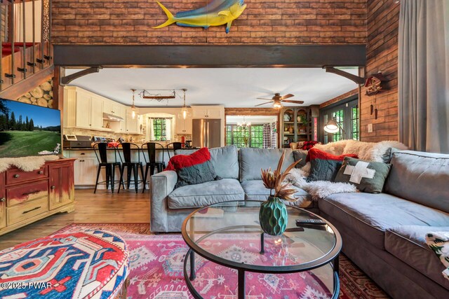 803 Deerfield Rd, Lake Ariel, PA 18436 - living area with healthy amount of natural light, wooden walls, wood finished floors, and a ceiling fan