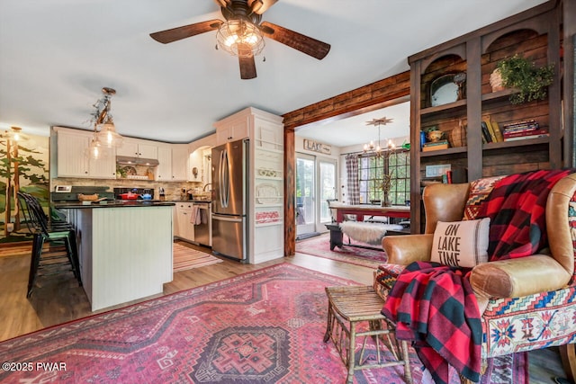 803 Deerfield Rd, Lake Ariel, PA 18436 - kitchen with dark countertops, appliances with stainless steel finishes, light wood-style floors, a ceiling fan, and a chandelier