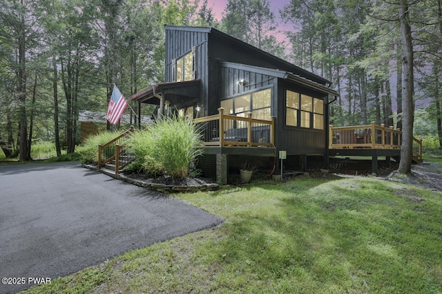 803 Deerfield Rd, Lake Ariel, PA 18436 - view of side of property with a sunroom, a wooden deck, and a yard