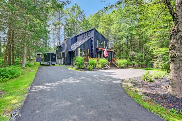 803 Deerfield Rd, Lake Ariel, PA 18436 - view of front facade featuring driveway, board and batten siding, and a forest view