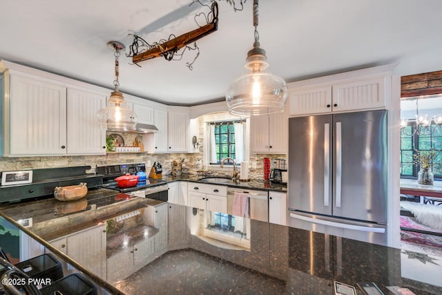 803 Deerfield Rd, Lake Ariel, PA 18436 - kitchen with appliances with stainless steel finishes, backsplash, a chandelier, white cabinetry, and hanging light fixtures