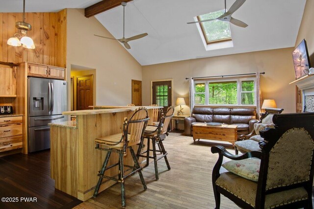 141 Constitution Dr, Lackawaxen, PA 18435 - kitchen with stainless steel refrigerator with ice dispenser, a ceiling fan, high vaulted ceiling, wood-type flooring, and beam ceiling