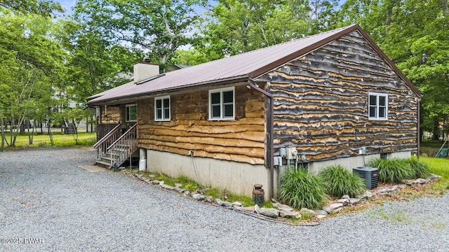 141 Constitution Dr, Lackawaxen, PA 18435 - view of property exterior with a chimney, metal roof, and cooling unit