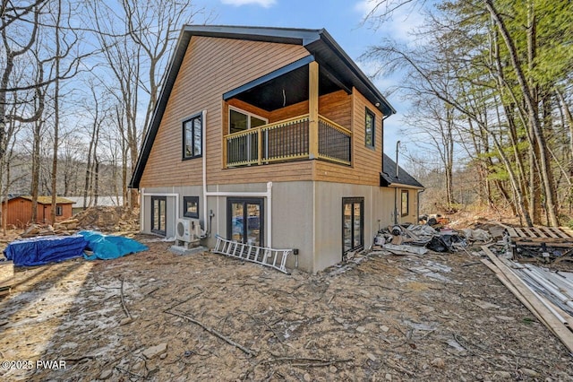 back of house featuring a balcony