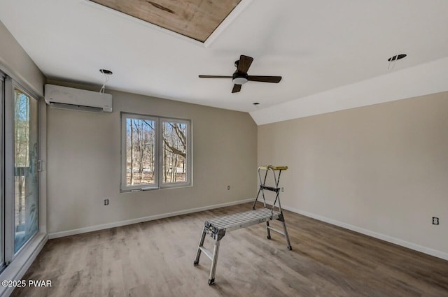 exercise room with vaulted ceiling, ceiling fan, hardwood / wood-style floors, and a wall unit AC