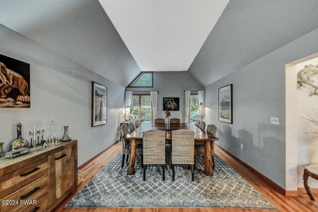 dining area with lofted ceiling and hardwood / wood-style flooring