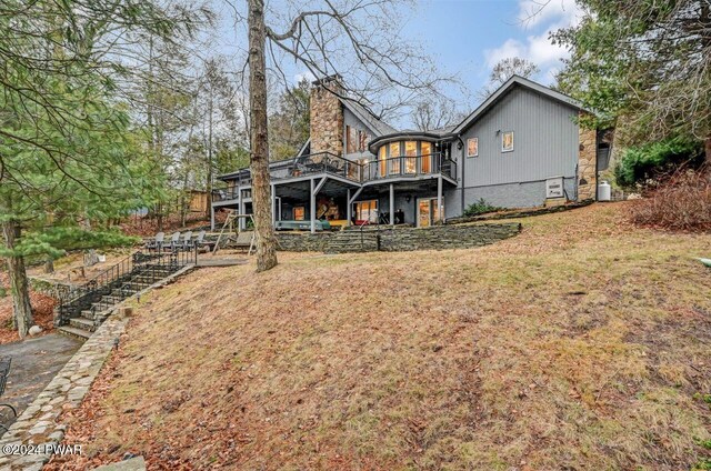 122 Waterfront Dr, Greentown, PA 18426 - rear view of house featuring stairs, a chimney, a deck, and a yard