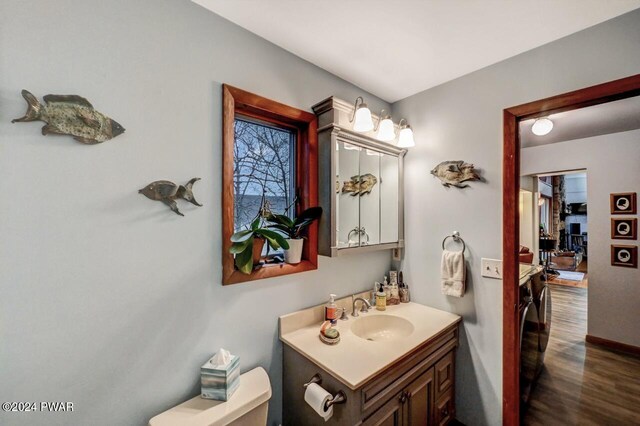 bathroom featuring vanity, hardwood / wood-style floors, and toilet