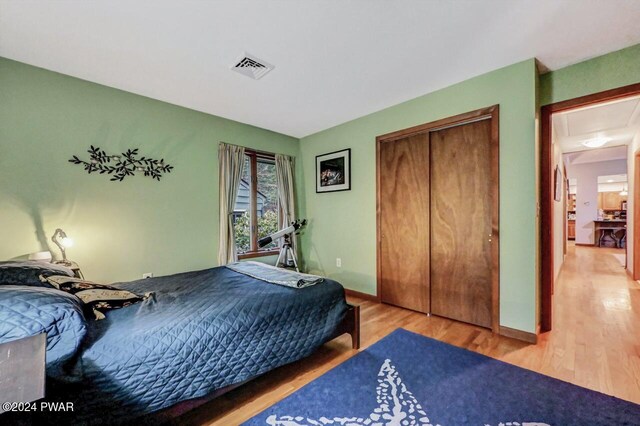 bedroom featuring hardwood / wood-style floors and a closet