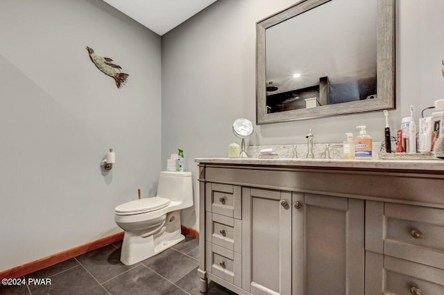 bathroom featuring tile patterned floors, vanity, and toilet