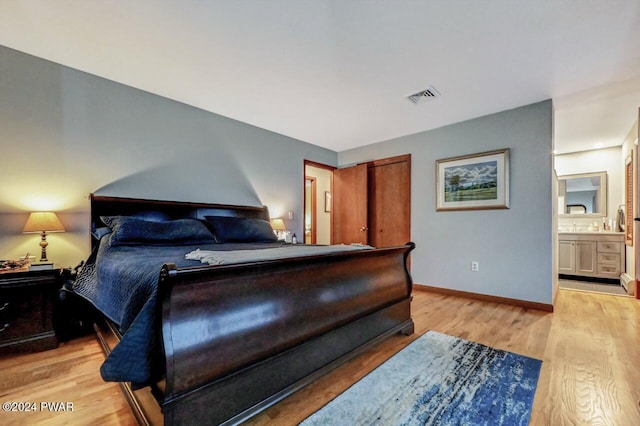 122 Waterfront Dr, Greentown, PA 18426 - bedroom with light wood-type flooring and ensuite bath