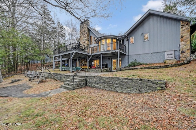 122 Waterfront Dr, Greentown, PA 18426 - back of house with a wooden deck and a chimney