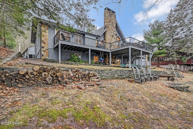 back of property with a wooden deck