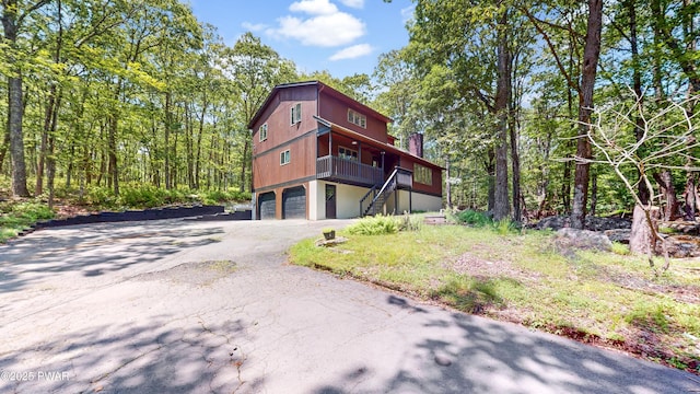 158 Wild Meadow Dr, Milford, PA 18337 - view of front of house with stairway, an attached garage, and asphalt driveway