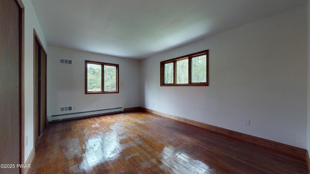 158 Wild Meadow Dr, Milford, PA 18337 - spare room featuring a baseboard heating unit and wood-type flooring
