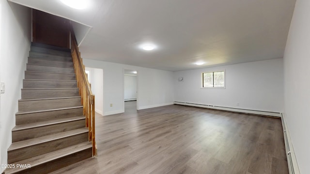 158 Wild Meadow Dr, Milford, PA 18337 - basement with stairway, a baseboard radiator, wood finished floors, and baseboard heating
