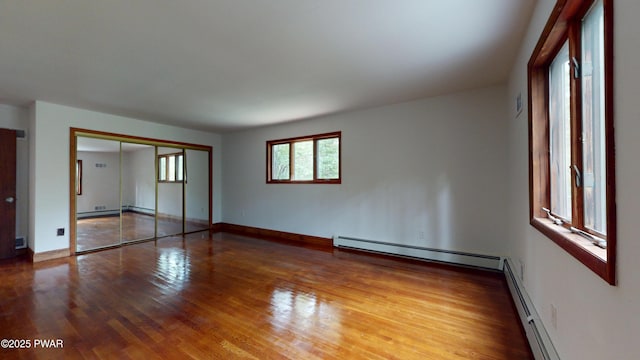 158 Wild Meadow Dr, Milford, PA 18337 - unfurnished bedroom with baseboard heating, wood finished floors, and a closet