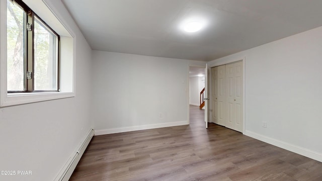 158 Wild Meadow Dr, Milford, PA 18337 - empty room with wood finished floors and a baseboard heating unit