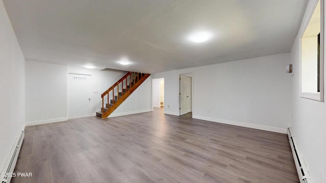 158 Wild Meadow Dr, Milford, PA 18337 - finished basement with baseboard heating, a baseboard radiator, stairs, and wood finished floors