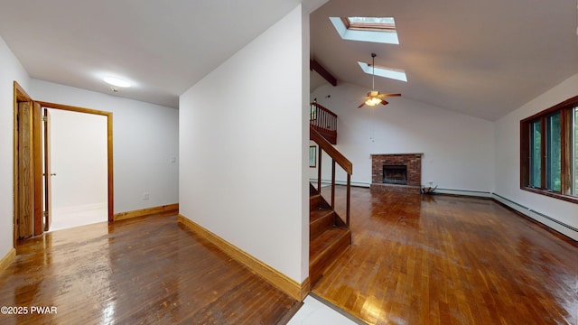 158 Wild Meadow Dr, Milford, PA 18337 - unfurnished living room with a baseboard heating unit, wood-type flooring, a fireplace, stairs, and ceiling fan