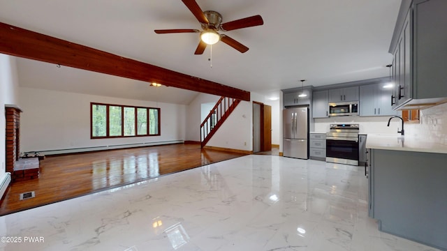 158 Wild Meadow Dr, Milford, PA 18337 - kitchen with appliances with stainless steel finishes, baseboard heating, gray cabinets, light marble finish flooring, and light countertops