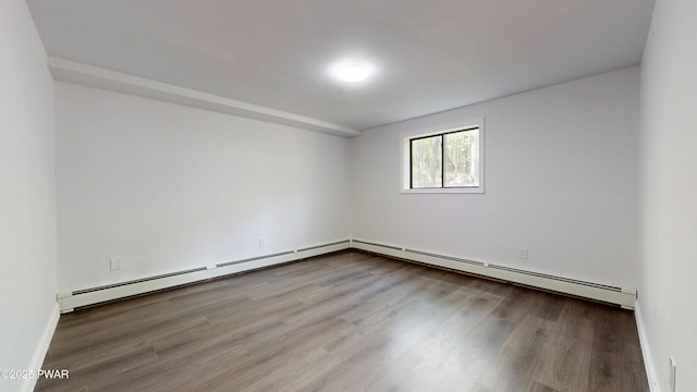 158 Wild Meadow Dr, Milford, PA 18337 - spare room featuring a baseboard heating unit and wood finished floors