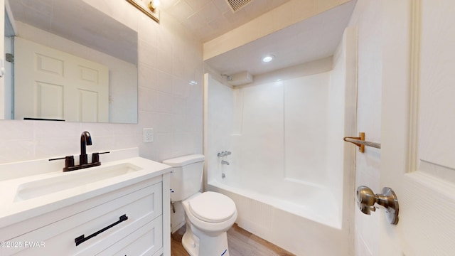 158 Wild Meadow Dr, Milford, PA 18337 - bathroom featuring vanity, tile walls,  shower combination, decorative backsplash, and wood finished floors