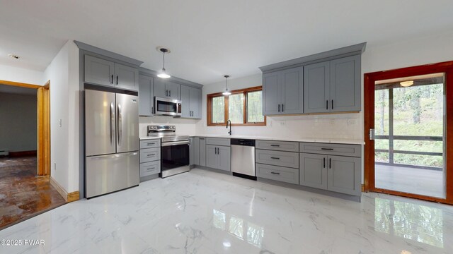 158 Wild Meadow Dr, Milford, PA 18337 - kitchen with stainless steel appliances, gray cabinetry, light marble finish floors, light countertops, and pendant lighting