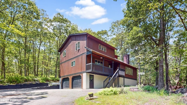 158 Wild Meadow Dr, Milford, PA 18337 - rear view of property featuring stairway, an attached garage, and asphalt driveway