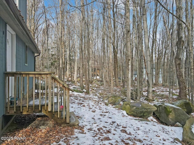 yard covered in snow with a wooden deck