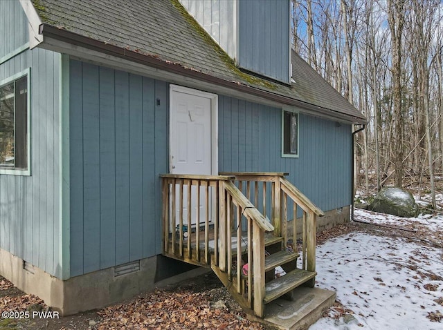 view of snow covered property entrance