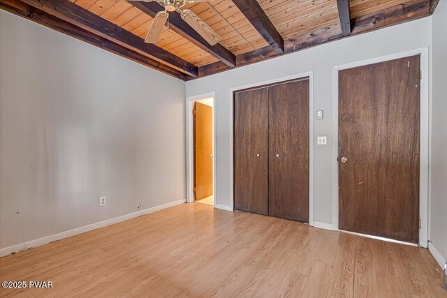 unfurnished bedroom with wood ceiling, light hardwood / wood-style flooring, and beamed ceiling