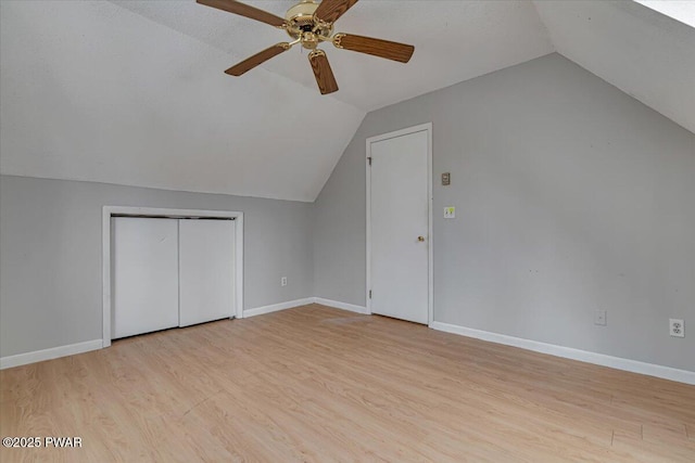 additional living space featuring ceiling fan, vaulted ceiling, and light wood-type flooring