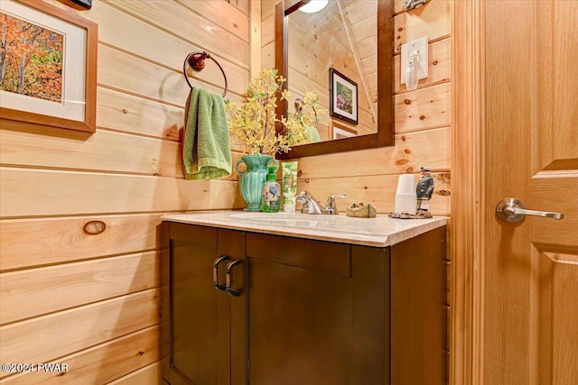 bathroom featuring vanity and wood walls