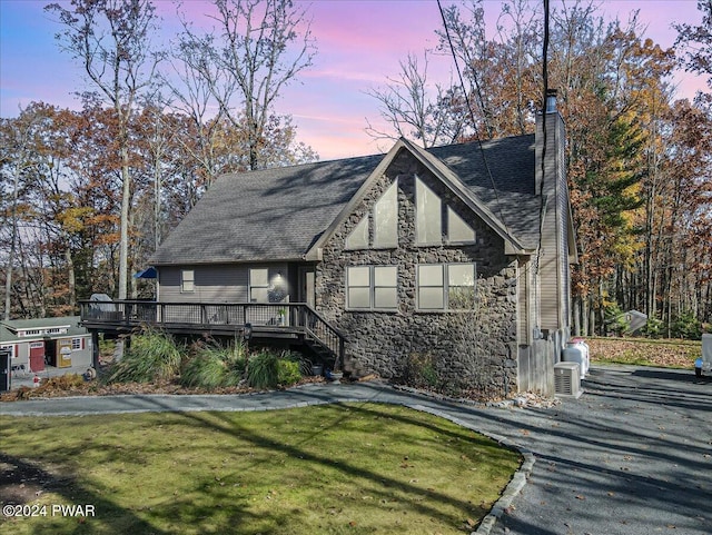 view of front of home featuring a yard and a deck