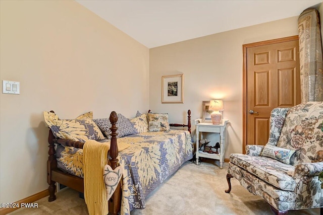 bedroom featuring light colored carpet and vaulted ceiling