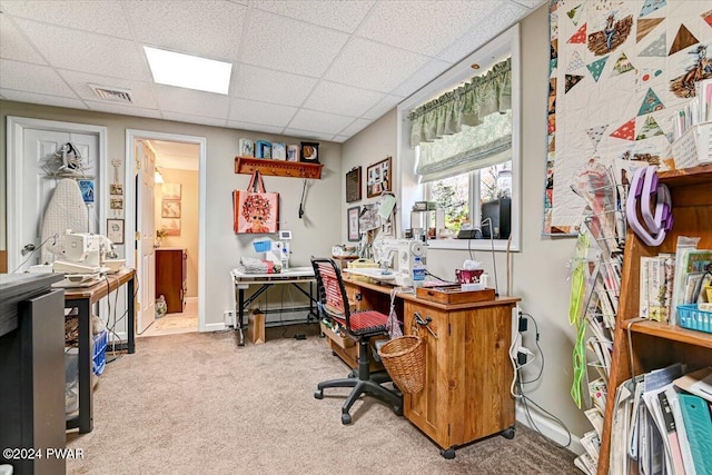 carpeted office space with a drop ceiling