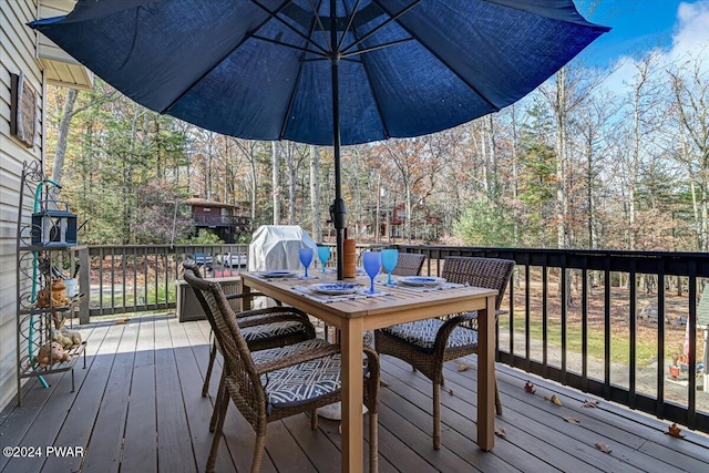 wooden deck with a grill