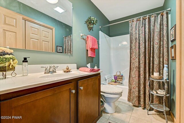 full bathroom with tile patterned flooring, vanity, toilet, and shower / bathtub combination with curtain