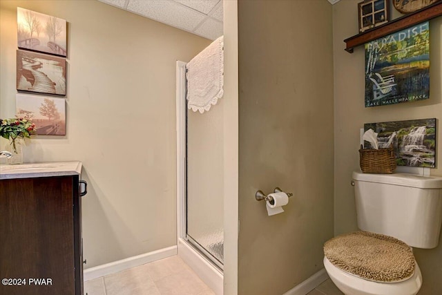 bathroom featuring walk in shower, a paneled ceiling, tile patterned flooring, and toilet