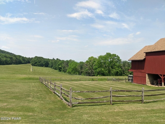 view of yard featuring a rural view and an outbuilding