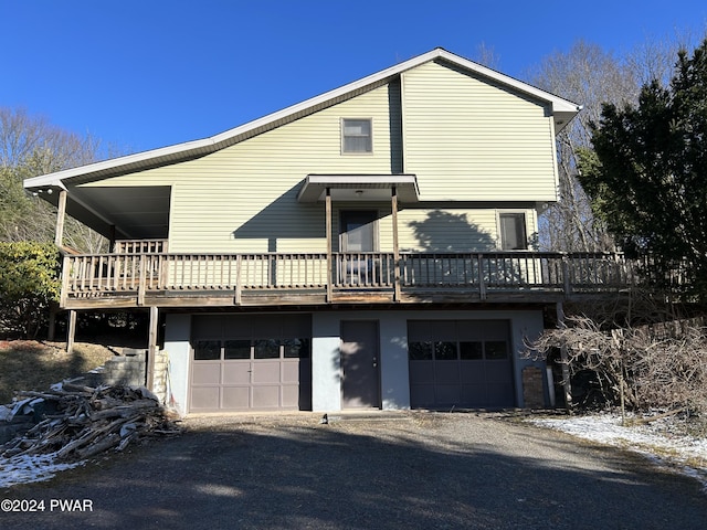 exterior space with a garage and a wooden deck