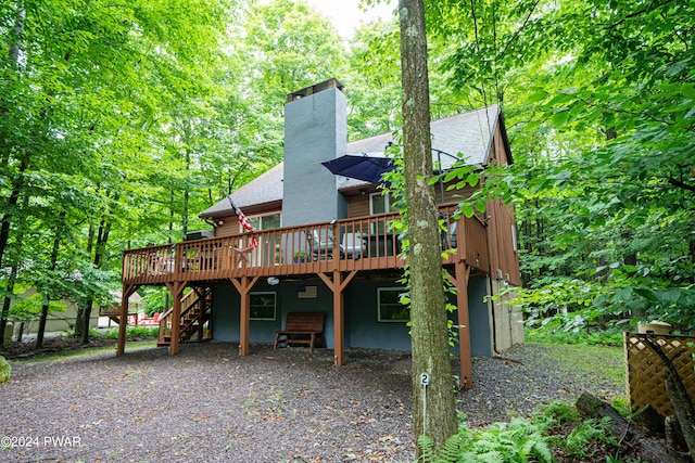 rear view of house with a wooden deck