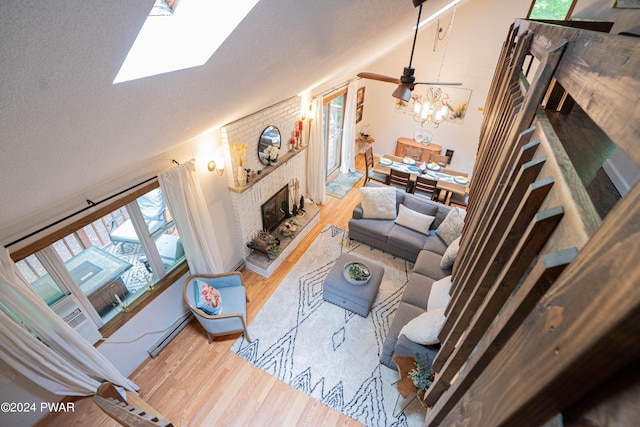 70 Underwood Ln, Lake Ariel, PA 18436 - living room with vaulted ceiling, light hardwood / wood-style flooring, ceiling fan, baseboard heating, and a fireplace