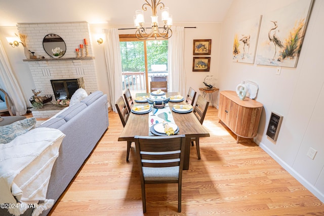 70 Underwood Ln, Lake Ariel, PA 18436 - dining space with an inviting chandelier, heating unit, lofted ceiling, a fireplace, and light wood-type flooring