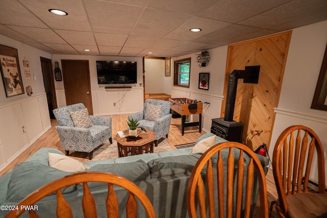 living room featuring light wood-type flooring and a wood stove